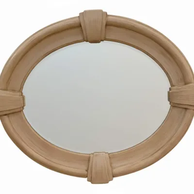 Sale Photo Thumbnail #47: Vintage oval wall mirror featuring a light-finished wood frame with decorative keystones at the top, bottom, and sides.