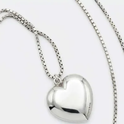 Sale Photo Thumbnail #83: Tiffany & Co. sterling silver puffed heart pendant necklace on a classic box chain, featuring the brand's signature engraving along the side.