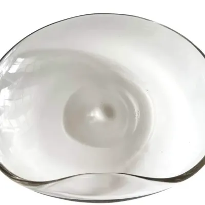 Sale Photo Thumbnail #12: Mid-century modern hand-blown clear art glass bowl, featuring an organic, asymmetrical rim and a central pontil mark.