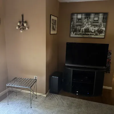 36" Sony flat screen TV, TV stand, metal table, wall photos 