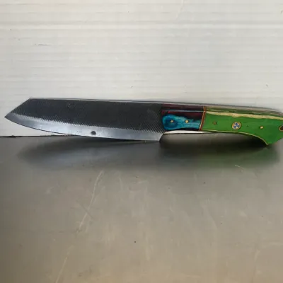 Sale Photo Thumbnail #35: Custom handmade knife crafted from a repurposed metal file, featuring a multi-colored laminated wood handle in green, blue, and red tones.