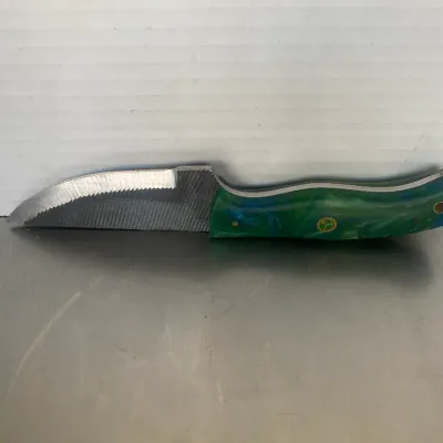 Sale Photo Thumbnail #50: Custom handmade knife crafted from a metal file, featuring a vibrant green and blue marbled resin handle with brass mosaic pins.