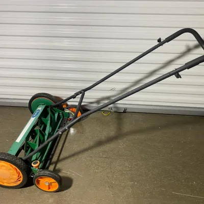 Sale Photo Thumbnail #6: Scotts classic push reel lawn mower featuring a green body with orange and black wheels, in gently used condition.