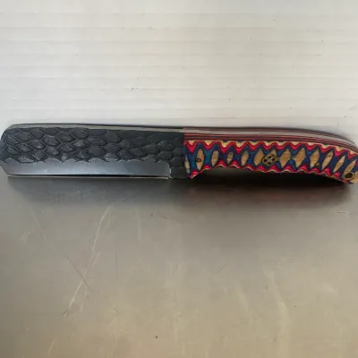 Sale Photo Thumbnail #62: Custom straight razor featuring a textured dragon scale pattern on the spine and a vibrant, multi-colored laminated wood handle.