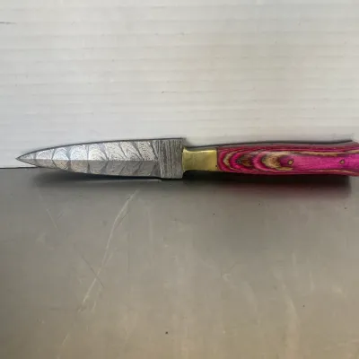 Sale Photo Thumbnail #31: Custom Damascus steel dagger featuring a double-edged blade, brass bolster, and a vibrant pink and natural wood grain laminated handle.