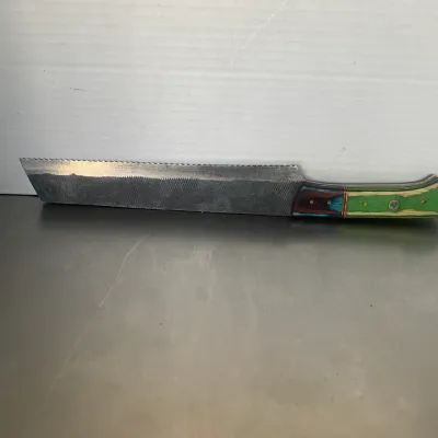 Sale Photo Thumbnail #42: Custom-made bread knife crafted from a repurposed metal file, featuring a serrated edge and a colorful laminated wood handle in green, blue, and red tones.