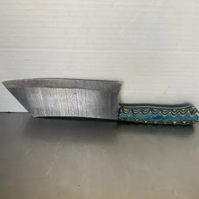 Sale Photo Thumbnail #38: Handmade Damascus steel cleaver knife featuring a textured blue and white wave-patterned handle.