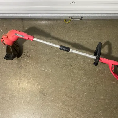 Sale Photo Thumbnail #10: Hyper Tough electric string trimmer with a red and black plastic body and an adjustable aluminum shaft.