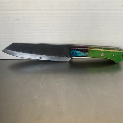 Sale Photo Thumbnail #69: Custom handmade knife crafted from a metal file, featuring a multi-colored laminated wood handle in green, blue, and red with brass pins.