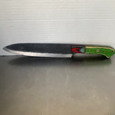 Sale Photo Thumbnail #29: Handmade custom knife crafted from a metal file, featuring a colorful laminated wood handle in shades of green, red, and blue.