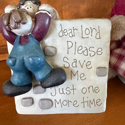 Sale Photo Thumbnail #158: A two-piece decorative lot featuring:
- A Boyds Bears & Friends plush teddy bear wearing a red and white plaid dress, a knit maroon cardigan sweater, and a lace collar. Includes original paper hang tag.
- A figurine depicting a boy climbing a wall with th