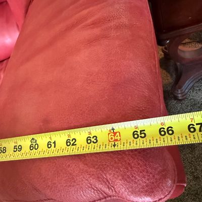 Sale Photo Thumbnail #96: A vibrant red leather loveseat by Natuzzi. Features plush, overstuffed armrests and back cushions. Shows some light wear and creasing consistent with gentle use, but remains in good, comfortable condition. Includes original Natuzzi documentation. Measures