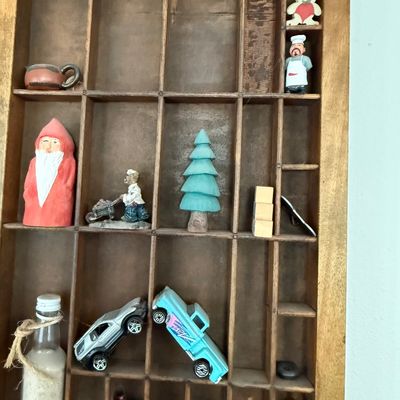 Sale Photo Thumbnail #195: A vintage wooden printer's type drawer repurposed as a hanging shadow box display case. Measures approximately 32 inches wide by 16.5 inches tall. The lot includes a large assortment of miniature collectibles, figurines, and novelty items as shown, includ