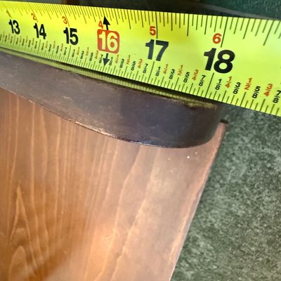 Sale Photo Thumbnail #241: A vintage wooden storage bench featuring a decorative spindle backrest, side handle cutouts, and a hinged seat that opens to a spacious storage compartment. The piece shows some light surface wear, minor scratches, and scuffs consistent with age and use. 