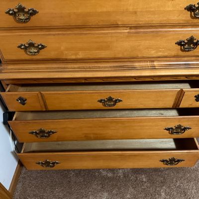 Sale Photo Thumbnail #218: A vintage solid wood chest-on-chest tallboy dresser manufactured by Crawford Furniture of Jamestown, New York. Features a classic colonial style with brass-toned batwing drawer pulls, bracket feet, and a total of seven drawers (including two faux-triple d