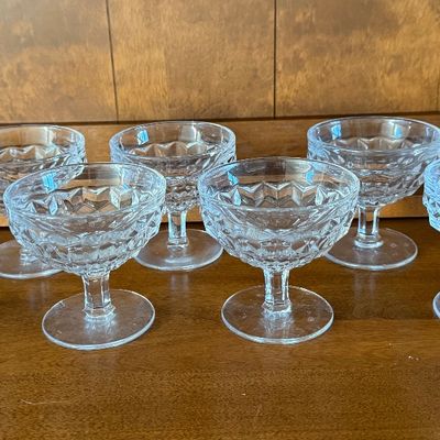Sale Photo Thumbnail #110: A matching set of eight vintage clear pressed glass dessert or sherbet cups. Features a classic diamond-cut textured pattern on the bowls with short, sturdy stems and round bases. Ideal for serving ice cream, fruit, or puddings. All pieces appear to be in