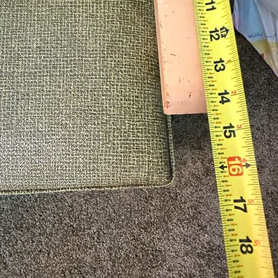 Sale Photo Thumbnail #244: A vintage child-sized armchair featuring a mid-century modern aesthetic. It is upholstered in a textured green woven fabric with light-colored wooden armrests and legs. The chair shows some signs of wear, including light scuffs and scratches on the wooden