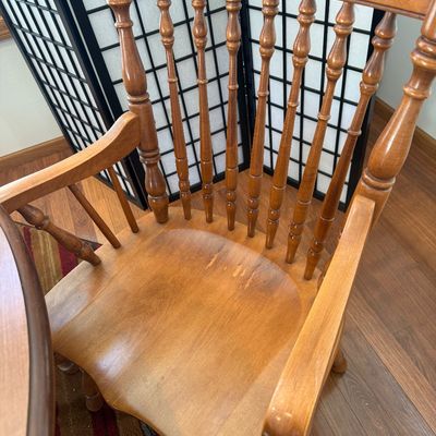 Sale Photo Thumbnail #6: NOT CHERRY IN COLOR.  A classic wooden dining set featuring an oval extension table and six matching Windsor-style chairs. The set includes two armchairs and four side chairs, all featuring turned spindle backs and legs. The table measures approximately 7