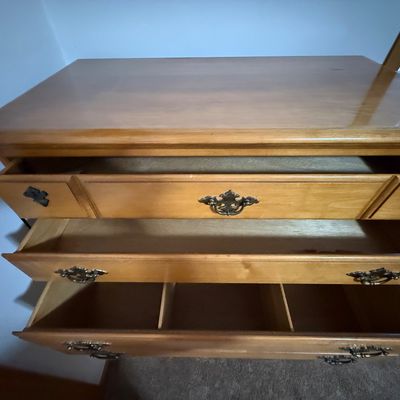 Sale Photo Thumbnail #219: A vintage solid wood chest-on-chest tallboy dresser manufactured by Crawford Furniture of Jamestown, New York. Features a classic colonial style with brass-toned batwing drawer pulls, bracket feet, and a total of seven drawers (including two faux-triple d
