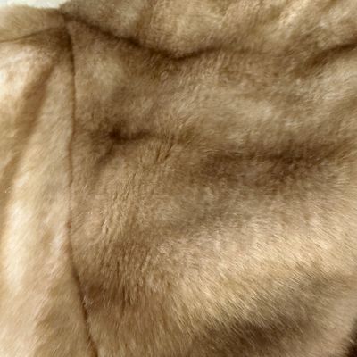 Sale Photo Thumbnail #276: A stylish Jones New York faux fur coat in a warm honey-blonde/tan color. Features a textured, ruffled collar, tiered panel design, and a smooth satin-like lining. Includes a gold-tone chain hanging loop. Size Large (L). Made in China. Appears to be in ver