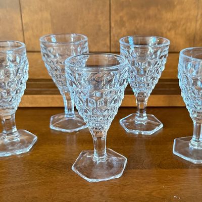 Sale Photo Thumbnail #115: A set of five vintage clear pressed glass goblets featuring a textured diamond/point pattern on the bowl and a hexagonal footed base. Each goblet measures approximately 4.5 inches tall. All pieces appear to be in good vintage condition with no visible chi