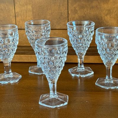 Sale Photo Thumbnail #117: A set of five vintage clear pressed glass goblets featuring a textured diamond/point pattern on the bowl and a hexagonal footed base. Each goblet measures approximately 4.5 inches tall. All pieces appear to be in good vintage condition with no visible chi
