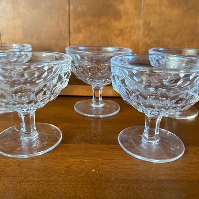 Sale Photo Thumbnail #112: A matching set of eight vintage clear pressed glass dessert or sherbet cups. Features a classic diamond-cut textured pattern on the bowls with short, sturdy stems and round bases. Ideal for serving ice cream, fruit, or puddings. All pieces appear to be in