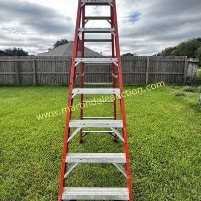Sale Photo Thumbnail #13: Werner 10ft  orange fiberglass A-frame stepladder, showing some wear from outdoor use.
