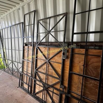 Sale Photo Thumbnail #20: Assorted black wrought iron security gates and window grilles in various geometric designs, showing some wear and weathering.