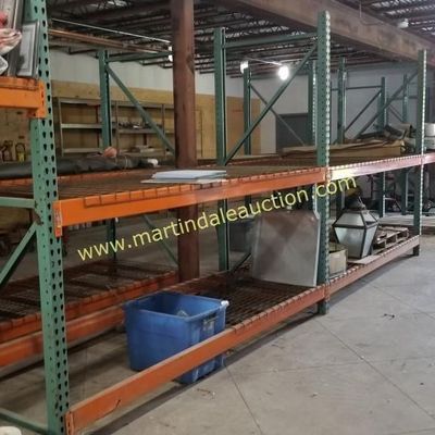 Sale Photo Thumbnail #62: Heavy-duty industrial pallet racking with green uprights, orange crossbeams, and wire mesh decking, shown in a warehouse setting.