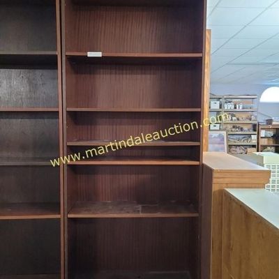 Sale Photo Thumbnail #52: Tall dark wood laminate bookcase with adjustable shelves, showing some wear from use.