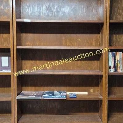 Sale Photo Thumbnail #55: Tall vintage wooden bookcase with adjustable shelves, showing some wear and dust from use.