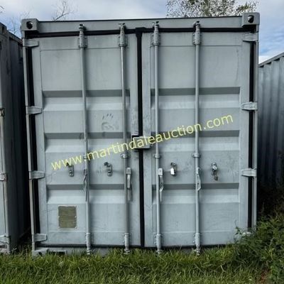 Sale Photo Thumbnail #39: Standard gray metal shipping container with double locking doors, showing some wear and weathering.