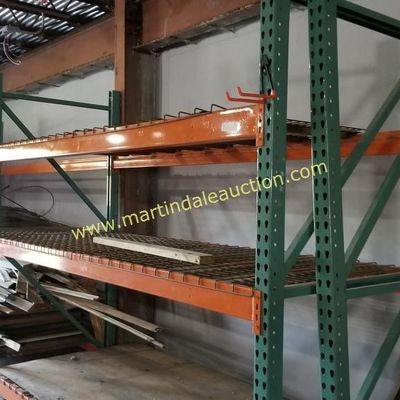 Sale Photo Thumbnail #61: Heavy-duty industrial pallet racking with green uprights and orange crossbeams, featuring wire mesh decking.
