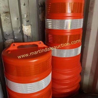 Sale Photo Thumbnail #32: Two stacks of orange plastic construction barrels with reflective white stripes and top handles.