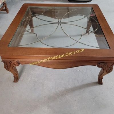 Sale Photo Thumbnail #2: Square wooden coffee table featuring a glass insert with an elegant leaded or metal overlay design, supported by carved cabriole legs.