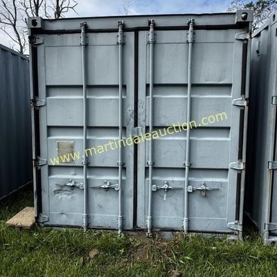 Sale Photo Thumbnail #37: Industrial steel shipping container in a light gray finish, showing some wear and minor denting on the doors.