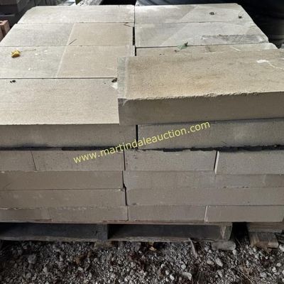 Sale Photo Thumbnail #11: Stack of rectangular concrete pavers or wall blocks on a wooden pallet, suitable for landscaping or hardscaping projects.