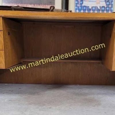 Sale Photo Thumbnail #3: Mid-century modern style oak executive desk featuring a floating drawer design, angled side panels, and a recessed modesty panel.