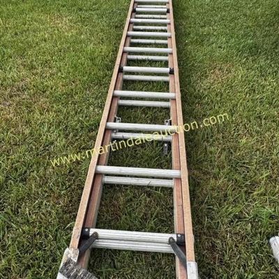 Sale Photo Thumbnail #16: 32ft fiberglass  aluminum extension ladder, showing some wear from outdoor use.