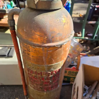 Sale Photo Thumbnail #19: Vintage Federal copper and brass fire extinguisher with a weathered patina and original red hose.