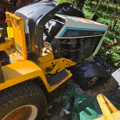 Sale Photo Thumbnail #42: Vintage Cub Cadet 782 Hydro garden tractor in yellow and white, showing some wear and rust from outdoor storage.