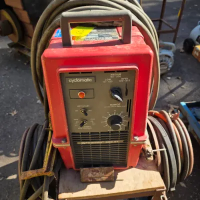 Sale Photo Thumbnail #40: PowCon 300 ST Cyclomatic welder in a red housing, mounted on a rolling cart with attached heavy-duty cables.