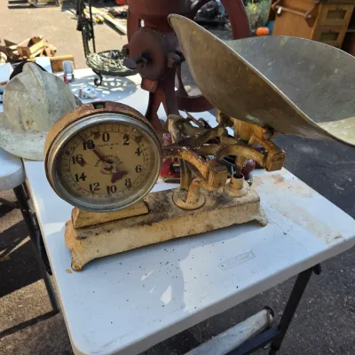Sale Photo Thumbnail #44: Vintage Penn Scale Mfg. Co. balance scale with a brass scoop and rusted cast iron base, showing significant wear and patina.