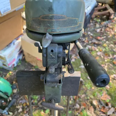 Sale Photo Thumbnail #16: Vintage Montgomery Ward Sea King outboard motor, model number 571-50301, showing significant wear and weathering.