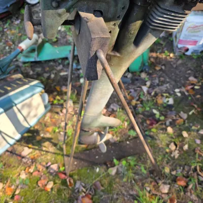 Sale Photo Thumbnail #14: Vintage elgin outboard boat motor mounted on a metal display stand, showing signs of wear and age.