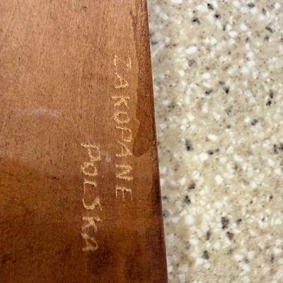 Sale Photo Thumbnail #5: Detail of a wooden item showing an engraved maker's mark or origin stamp reading "ZAKOPANE POLSKA".