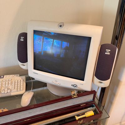 Sale Photo Thumbnail #296: Vintage Compaq FS740 CRT computer monitor with side-mounted JBL speakers, accompanied by a matching keyboard and mouse, circa early 2000s.