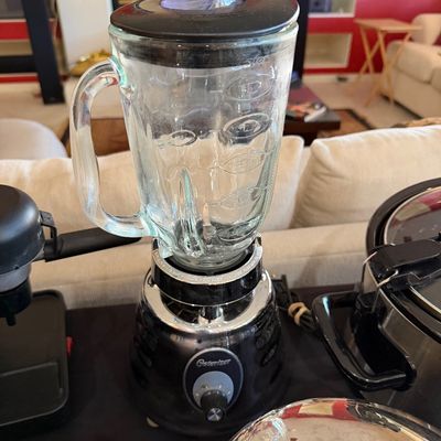 Sale Photo Thumbnail #268: Osterizer blender featuring a chrome and black base with a heavy glass pitcher and black lid.