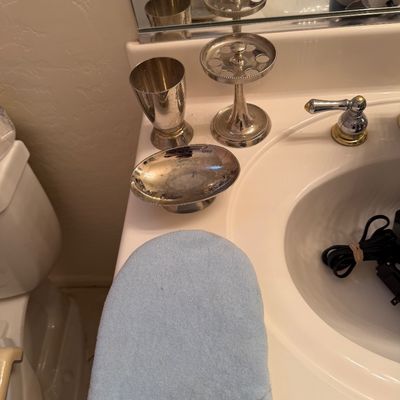 Sale Photo Thumbnail #160: Vintage silver-plated bathroom vanity set, including a tumbler, a pedestal soap dish, and a toothbrush holder, showing some tarnish.